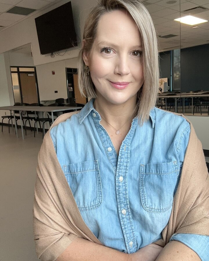 Profile picture of Katie Carlson in light blue shirt with tan cardigan